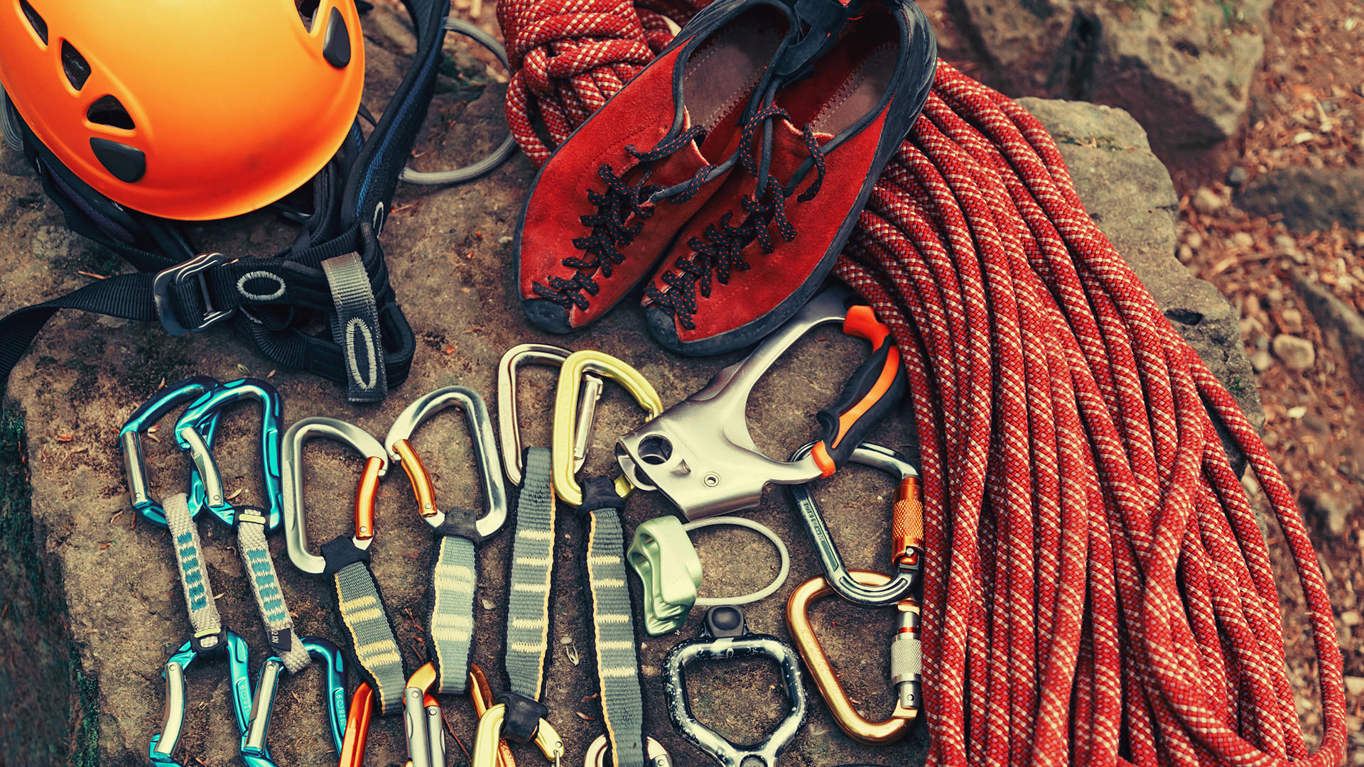 Carabiners, quickdraws, and protection racked on a harness — the same discipline as checking border kit before a desert traverse, when the car door closes and cell coverage disappears