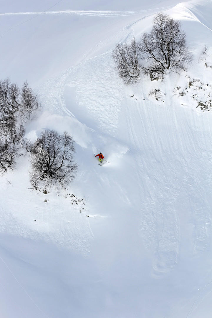 Skier in deep powder, extreme mountain freeride