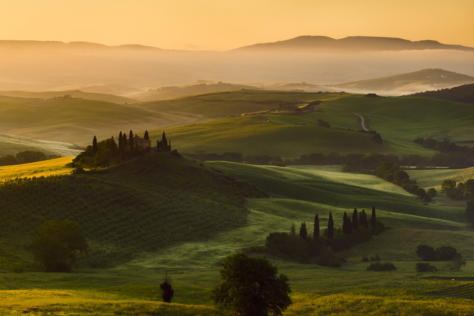 Orcia Valley at sunrise, Tuscany — the same pre-dawn stillness that greets every Alpine pass cyclist before the first big climb