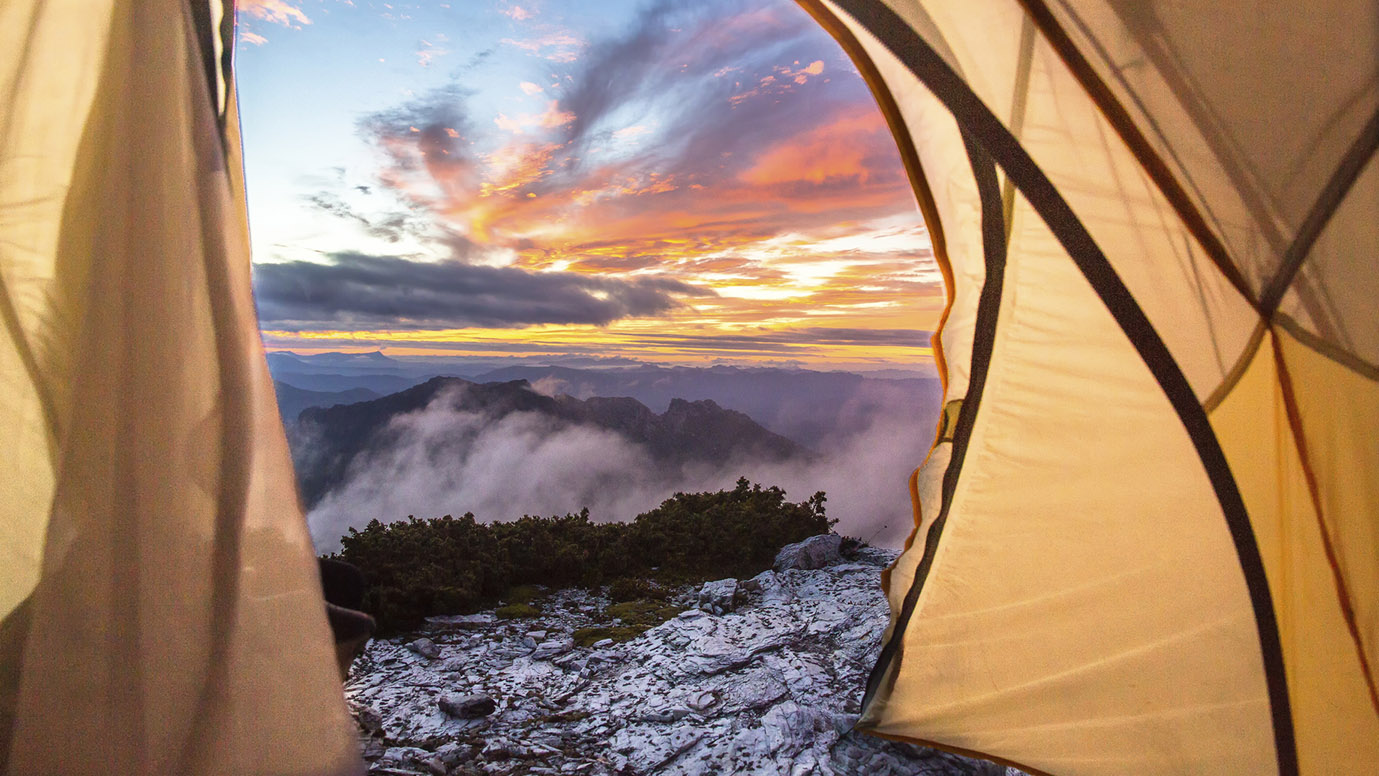 Dawn sky from inside a tent pitched on Frenchman's Cap, Tasmania — the reward for getting your shelter right and your weight exactly where it needs to be