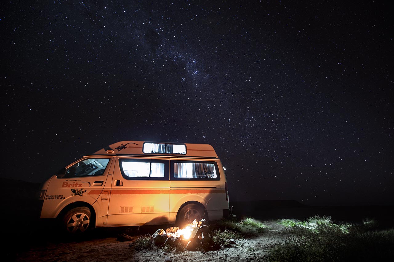 The WKND team gathered around a table in the field