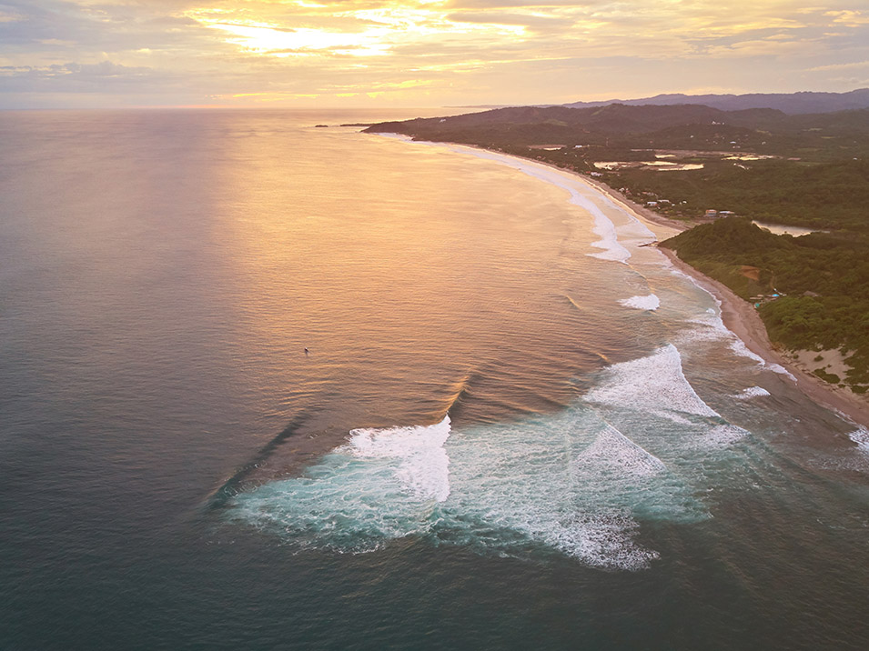 Aerial drone view of a famous surfing bay in Nicaragua at sunset