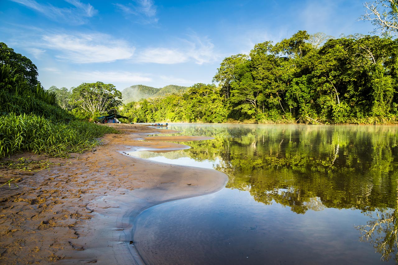 Golden light reflecting on the still surface of the Amazon River, Brazil