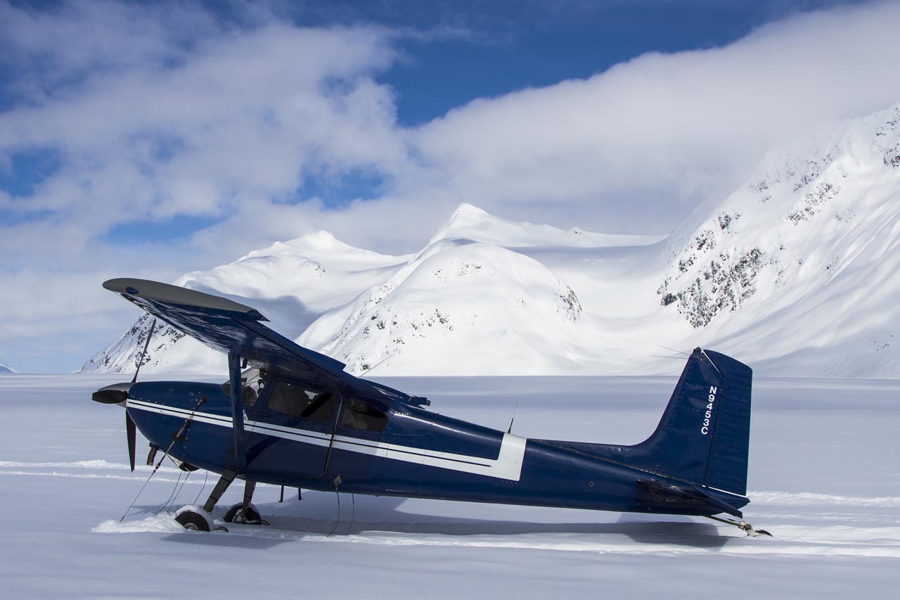 Small float or ski plane on a gravel airstrip deep in the Alaskan wilderness